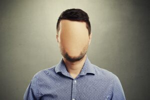 anonymous man with blank face against dark background