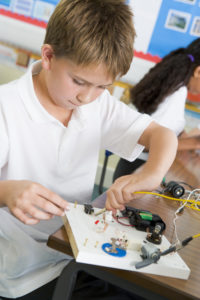 A schoolboy in a science class